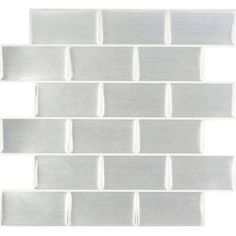 a white tile wall that is made up of squares