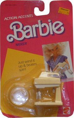 a toy car that is sitting on the floor in front of a package for barbie