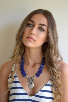 This handmade choker necklace is a beautiful combination of Lapis Lazuli big stones and beautiful Antique Silver plated pendant, that create an exotic color combination. This is a fashionable, one of a kind necklace. It is super cool, with such a great bohemian look. please check my website. See my unique collection: www.ninnos.etsy.com www.ninonarimanidze.com Bohemian Lapis Lazuli Beaded Necklace With Gemstones, Bohemian Gemstone Choker Necklace, Blue Gemstone Accents Necklace, Blue Lapis Lazuli Jewelry For Festivals, Bohemian Lapis Lazuli Jewelry With Gemstone Beads, Handmade Lapis Lazuli Jewelry For Festivals, Festival Jewelry With Gemstones, Bohemian Jewelry With Natural Lapis Lazuli Stones, Handmade Lapis Lazuli Necklaces