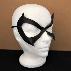 DESCRIPTIONSleek & sexy, lightweight leather Black Cat mask is an awesome costume accessory for Felicia Hardy, Ms. Marvel, Batgirl, Catwoman Cosplay or Halloween. Great convention mask; For villian & superhero cosplay, Halloween or Comicon. Spice up Valentine's Day! Any color. Waterproofed leather, glossy or matte finish, & several choices to affix the mask (cord, elastic, ribbon, waterproof cord, stick, or no holes for adhesive). Measurements: 7" high x 5" wide (tallest & widest Black Cosplay Costume For Masquerade And Cosplay Events, Black Cosplay Costume For Masquerade, Black Cosplay Costume For Masquerade Events, Black Masquerade Cosplay Costume With Mask, Black Cat Ears Fantasy Costume Accessories, Black Fantasy Cat Ears Costume Accessories, Fantasy Eye Mask For Cosplay, Black Masks For Cosplay Costume Events, Adjustable Masks And Prosthetics For Cosplay Events