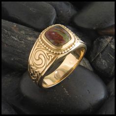 The Churaich Ring is set with Iona Bloodstone, or Connemara Marble and available in your choice of 14K Yellow, Rose or White Gold, Sizes 7 to 14. An original design by Stephen Walker of Walker Metalsmiths. Celtic jewelry inspired by the heritage of Ireland and Scotland. Made in USA. Add Engraving Available in Sterling Silver. Item number: R14Original designs © Stephen WalkerPlease call or email for more information 800.488.6347 or service@walkermetalsmiths.com Mens Celtic Rings, Antique Mens Rings, Heart Knot Ring, Gold Celtic Rings, Custom Gold Rings, Purple Sapphire Ring, Pear Cut Diamond Ring, Celtic Knot Ring, Celtic Wedding Rings