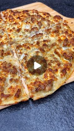 a pizza sitting on top of a wooden cutting board