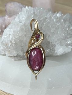 Ruby 14k Gold Filled Wire Wrapped Pendant, complete with a luxurious 22" adjustable necklace. Harnesses the remarkable healing powers of Ruby, a gemstone celebrated for its ability to foster courage, improve energy levels, and promote emotional vitality. This exquisite piece not only enhances your wardrobe but also serves as a beacon of passion and protection. Ideal for daily wear or special occasions, our pendant invites you to experience the joy and empowerment of Ruby's vibrant energies. This Spiritual 14k Gold Gemstone Jewelry, Spiritual Yellow Gold Jewelry With Gemstones, Spiritual Rose Gold Round Pendant Jewelry, Adjustable Yellow Gold Gemstone Jewelry, Adjustable Yellow Gold Ruby Jewelry, 14k Gold Spiritual Round Pendant Jewelry, Gold Sterling Silver Jewelry With Cabochon, Spiritual 14k Gold Round Pendant Jewelry, Spiritual 14k Gold Round Pendant