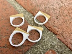 two pairs of white and gold scissors on the ground