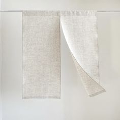 two white linens hanging on the wall