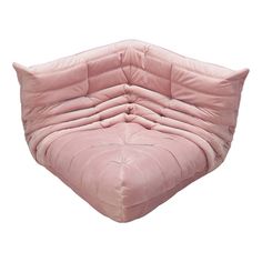 a pink couch that is shaped like a heart