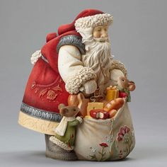 a santa clause figurine holding a bag full of toys