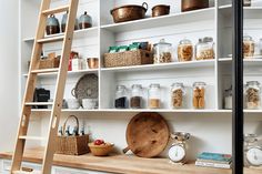 the shelves in this kitchen are filled with spices and other things to cook or eat