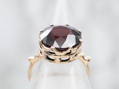 This is a gorgeous yellow gold mounting in which we've set a luscious garnet that has deep crimson undertones to perfectly complement this pretty mounting, making this one exceptional ring!Metal: 14K Yellow GoldGem: Garnet 9.16 CaratsGem Measurements: 12.2 mm, RoundRing Size: 7.25Marks: "14K" Stamped on the inside band Formal Garnet Burgundy Ring, Formal Burgundy Garnet Ring, Classic Burgundy Ruby Ring For Formal Occasions, Classic Formal Burgundy Rings, Elegant Garnet Solitaire Ruby Ring, Elegant Solitaire Garnet Ruby Ring, Formal Round Cut Garnet Rings, Formal Garnet Rings With Brilliant Cut, Classic Ruby Ring With Brilliant Cut Garnet