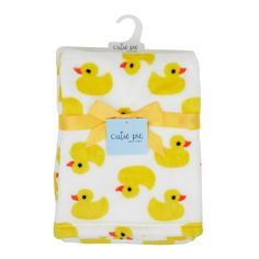 a white blanket with yellow rubber ducks on it and a tag that says cutie pie