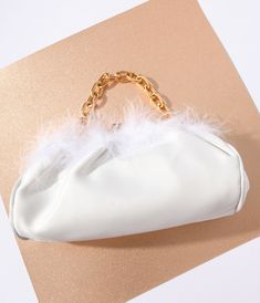 Crafted from a beautiful white satin, its soft fur trim adds a touch of glamorous charm that's simply irresistible. With its gleaming gold hardware and chain top handle, this clutch exudes pure sophistication at every turn. The convenient snap closure secures your valuables while the inner slip pocket keeps essentials within reach. And guess what? You can effortlessly transform it into a stylish crossbody bag by attaching the removable gold chain strap. White Party Bags With Gold-tone Hardware, Trendy White Evening Bag For Formal Events, Trendy White Evening Bag For Parties, Elegant Faux Fur Bags For Winter, Elegant Faux Fur Winter Bag, Elegant Rectangular Faux Fur Bag, White Evening Bag With Gold-tone Hardware, White Clutch With Gold-tone Hardware For Evening, Elegant Bags With Feather Trim For Events