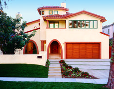 a large house with two garages and steps leading up to the front door is shown