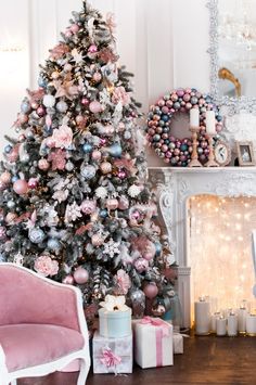 a decorated christmas tree in a living room with pink and silver ornaments on the mantle