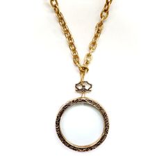 Handcrafted one-of-a-kind necklace, stunning giant vintage magnifying glass pendant, vintage toggle closure, finished with green leather and vintage danglers. Wear it long or doubled over. Dress it up or down, chic timeless classic and super stylish! The Necklace measures 30" in length Vintage brass chain Vintage magnifying glass pendant Made with love in Los Angeles Complimentary gift wrapping provided All sales final Vintage Brass Medallion Necklace With Adjustable Chain, Vintage Locket Necklace With Lobster Clasp, Vintage Locket Necklace With Round Pendant, Vintage Medallion Locket Necklace With Lobster Clasp, Vintage Necklace With Detachable Round Pendant, Vintage Gold Toggle Necklace, Vintage Medallion Necklace With Chain, Over Dress, Magnifying Glass