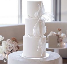 a white wedding cake sitting on top of a table