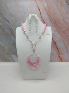 "Handmade and designed by me-one of a kind necklace set-spiral bead crochet necklace with pink seed beads-20 1/2\" long-3 1/4\" long focal with a cat's eye bead and a hand crafted wire wrapped pendant-cat's eye beads-metal beads-2\" long dangle earrings-toggle clasp in front-silver tone. This beautiful necklace set is eye catching and would definitely get you compliments! Makes a great addition to your jewelry wardrobe! Easy on because of the toggle clasp is in the front." Pink Wire Wrapped Necklace, Spiral Beaded Necklaces As Gifts, Spiral Beaded Necklace For Gift, Spiral Beaded Necklace For Gifts, Spiral Beaded Necklace As Gift, Handmade Pink Crystal Necklaces, Handmade Pink Round Crystal Necklaces, Handmade Pink Crystal Round Necklaces, Pink Spiral Jewelry For Gifts