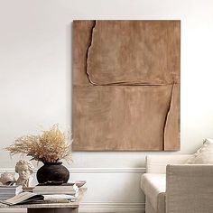 a living room filled with furniture and a painting on the wall over a coffee table