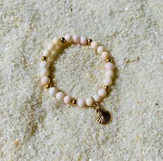 "THE perfect baby shower, new born baby gift. Conch Sea Shell beads on a strong elastic band with 14k gold filled beads and a 14k gold filled sea shell charm. 100% Ocean proof & perfect for everyday use without the need to be taken off. Floridian Ocean Jewelry ™ \"For Mermaid Babies\"" Gold Shell Beaded Bracelets As Gift, Gold Stackable Stretch Bracelet For The Beach, Gold Spiritual Stretch Bracelet For Beach, Sea Shell Bracelet, Baby Mermaid, Coral Bracelet, Ocean Jewelry, New Born Baby, Perfect Baby Shower