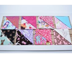 a group of different colored handkerchiefs on a table next to some wood planks