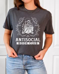 Looking for the perfect gift for a book-loving friend or family member? Look no further than this Comfort Colors T-shirt for the Anti-Social Book Club. With its stylish design and comfortable fit, this shirt is sure to be a hit with any bookworm or booktrovert. Bookish Crew Neck T-shirt With Letter Print, Bookish Cotton T-shirt With Letter Print, Screen Print Short Sleeve Tops, Literary Style Short Sleeve Screen Print Tops, Literary Crew Neck T-shirt With Screen Print, Screen Print Crew Neck T-shirt, Literary Relaxed Fit Crew Neck T-shirt, Relaxed Fit Pre-shrunk Bookish T-shirt, Black Bookish T-shirt With Screen Print