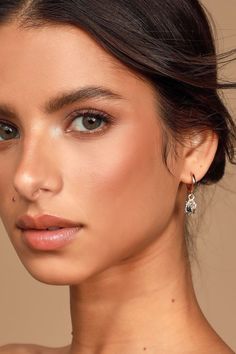 a close up of a woman wearing earrings