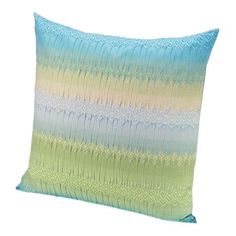 a blue and green pillow on a white background with an image of the same color