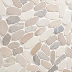 a close up view of a stone wall with different colored stones on it's surface