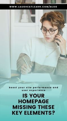 a woman sitting at a desk talking on her cell phone and writing in a notebook