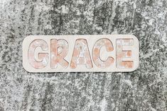 the word grace is written in large letters on a stone surface