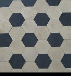 a black and white tiled floor with hexagonal tiles