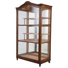 a wooden display case with glass doors and shelves on each side, in the shape of a bookcase