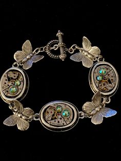 Unique Bracelet with Butterfly and watch movement's. Personalize with your choice of Swarovski crystals  Steampunk Jewelry Bracelet  One-of-a-Kind Handcrafted Jewelry Created with Recycled Vintage Watch Parts and Found Objects This bracelet incorporates vintage beautiful watch parts, gears, and real watch movements embellished with Swarovski crystals in Borealis.  It incorporates Antique Silver Beautiful Butterflies A truly unique one of a kind piece. Great for a gift. This bracelet measures 8 i Steampunk Mixed Media Art, Butterfly Watch, Bracelet Butterfly, Steampunk Mixed Media, Butterfly Charm Bracelet, Jewelry Butterfly, Butterfly Bracelet, Watch Parts, Steampunk Jewelry