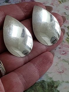 This is a vintage, sterling silver, tear drop, post earrings for pierced ears. They have tested positive for silver. These earrings measure 1.5 inches in length. Don't forget to stop in at my other Etsy shop... http://www.etsy.com/shop/xtdesigns. Follow me on Twitter at... MyYiayiaHadThat@MyYiayiaHadThat. If you have a wish list or are looking for something specific, please ask. I may have exactly what you are looking for. As always please convo me with any questions or concerns regarding this i Vintage Silver Teardrop Clip-on Earrings, Formal Silver Teardrop Clip-on Earrings, Silver Teardrop Nickel-free Clip-on Earrings, Silver Teardrop Clip-on Earrings For Formal Occasions, Nickel Free Silver Teardrop Clip-on Earrings, Nickel-free Silver Teardrop Clip-on Earrings, Silver Teardrop Clip-on Earrings, Silver Teardrop Clip-on Earrings As Gift, Silver Teardrop Clip-on Earrings For Gift