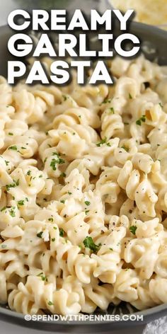 creamy garlic pasta in a skillet with parsley on top and text overlay