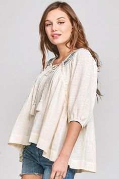 Peasant Embroidered Top – Mota Boutique Spring V-neck Blouse With Tassel Ties, Flowy Cotton Blouse With Floral Embroidery, Bohemian Peasant Top With Embroidered Neckline For Spring, Bohemian Peasant Top With Back Tassel Tie-up, Summer Beach Peasant Top With Tassel Ties, Summer Peasant Top With 3/4 Sleeves, Summer V-neck Peasant Top With Tassels, Peasant Style 3/4 Sleeve Top For Summer, Peasant Style 3/4 Sleeve Summer Top