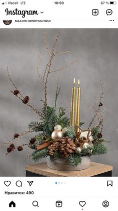 a vase filled with pine cones and candles