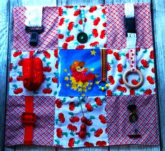 an assortment of items displayed on top of a piece of cloth covered in red and white fabric