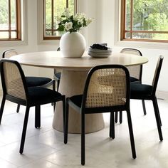 a round table with four chairs around it