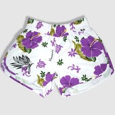 Black shorts with purple hibiscus flower. Made of 100% microfiber polyester. Designed and shipped from Hawaii and made in Vietnam. Colors and fabric may vary from picture depending on cut. Beach Floral Print Stretch Shorts, Stretch Floral Print Beach Shorts, Stretch Floral Print Shorts For Beach, Hawaiian Style Surfing Shorts, Hawaiian Swim Trunks With Built-in Shorts, Purple Swimming Shorts For Summer, Summer Purple Athletic Shorts With Elastic Waistband, Summer Athletic Shorts With Elastic Waistband In Purple, Hawaiian Style Short Swim Trunks