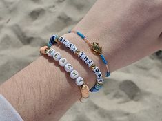 Trendy chunks of clay heishi beads with gold accent beads and durable elastic cord make up this adorable bracelet set that is perfect for any beach lover! Choose from 1 - 6 colors, gold or silver accent beads, and size. I also have the round letters available in white with silver letters as well. These accent beads shown on the "Beachy" bracelet are non-magnetic synthetic hematite that is platinum plated and golden plated. The turtle bracelet is made with a Tibetian Gold Turtle bead made out of Gold Beaded Bracelets With Letter Beads For Vacation, Adjustable Stretch Bracelet With Letter Beads For Vacation, Adjustable Letter Beads Stretch Bracelet For Vacation, Gold Beaded Bracelets With Letter Beads For Beach, Gold Heishi Beaded Bracelets For Vacation, Beachy Adjustable Beaded Bracelets With Letter Beads, Adjustable Beachy Beaded Bracelets With Letter Beads, Letter Beads Beaded Bracelet For Beach Vacation, Heishi Beads Stretch Bracelet With Tiny Beads For Beach