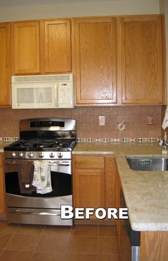 a kitchen with wooden cabinets and stainless steel stove top oven next to a white microwave