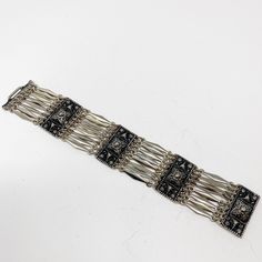 Picturing Taxco Sterling silver Gerardo Lopez sectional bracelet. 1930's Mexican sterling silver art deco period bracelet with wide spacers and stamped motif panels. Hidden clasp. Sterling, Taxco, 325 Please see pictures for approximate measurements and condition. Excellent vintage condition with expected signs of wear from vintage item. Measurements: width top to bottom: 1 3/8in length end to end: 8in weight: 2oz RHF-75