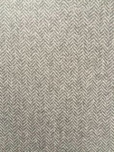 an upholstered gray and white herringbone fabric