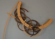 a clock made out of wooden gears on a wall