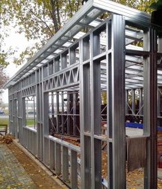 a metal structure is being constructed on the side of a road