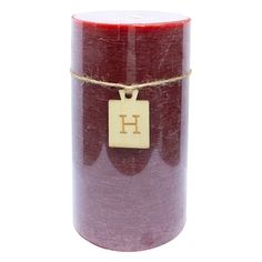 a red candle with a tag on it