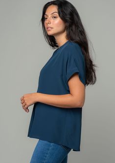 An unbelievably soft and silky hand feel elevates this classic short sleeve top. Featuring a cuffed sleeve, a flattering v-neckline, and a flowy, relaxed fit. Try it loose over jeans for a cool and casual vibe, or tuck it into trousers for a polished look. Silky crepe Relaxed fit V-neckline Short cuffed sleeve Banded collar Split neckline Bohemian top Model is 5'9, wearing a size S.Style: I-13140W-RPL Casual V-neck Blouse With Rolled Sleeves, Everyday Blue Tops With Rolled Sleeves, Blue Top With Rolled Sleeves For Everyday, Blue Tops With Rolled Sleeves For Everyday, Relaxed Fit V-neck T-shirt For Casual Gatherings, Casual Blue V-neck Short Sleeve Top, Casual V-neck Blouse, Chic Blue Top With Cuffed Sleeves, Blue Short Sleeve Top For Casual Wear