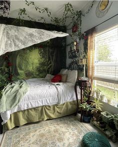 a bedroom with a canopy bed and plants on the wall