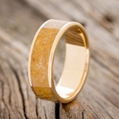 a wooden ring with yellow sand in it