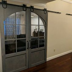 a living room with sliding glass doors and hardwood floors